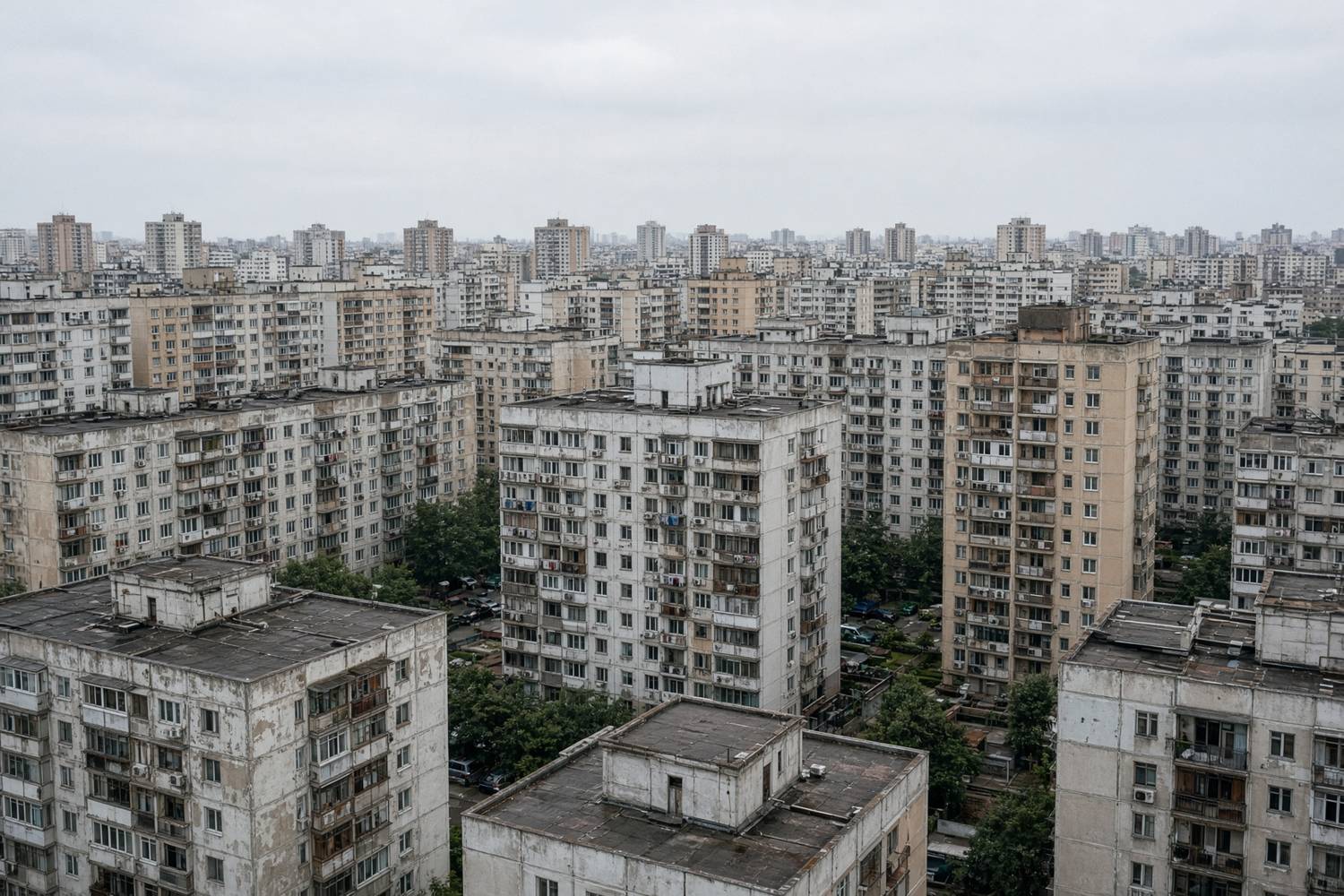 Mid-rise apartment blocks under an overcast sky.